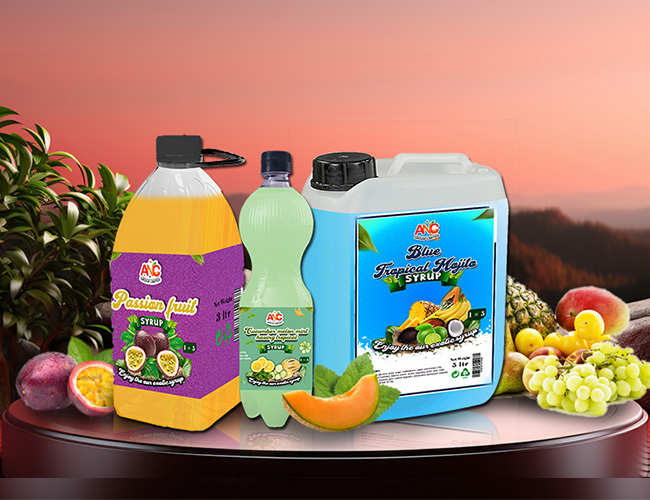 A variety of ANC syrups, including passion fruit, lime, and blue tropical, displayed with fresh fruits, highlighting their rich and natural flavors.